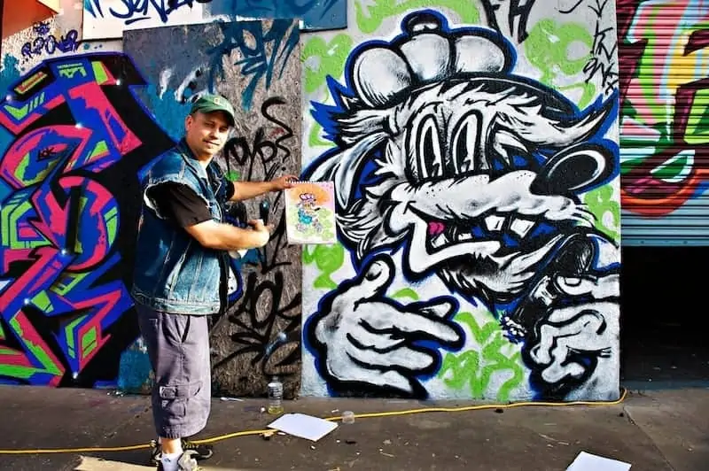 Graffiti artist showing concept and finished product