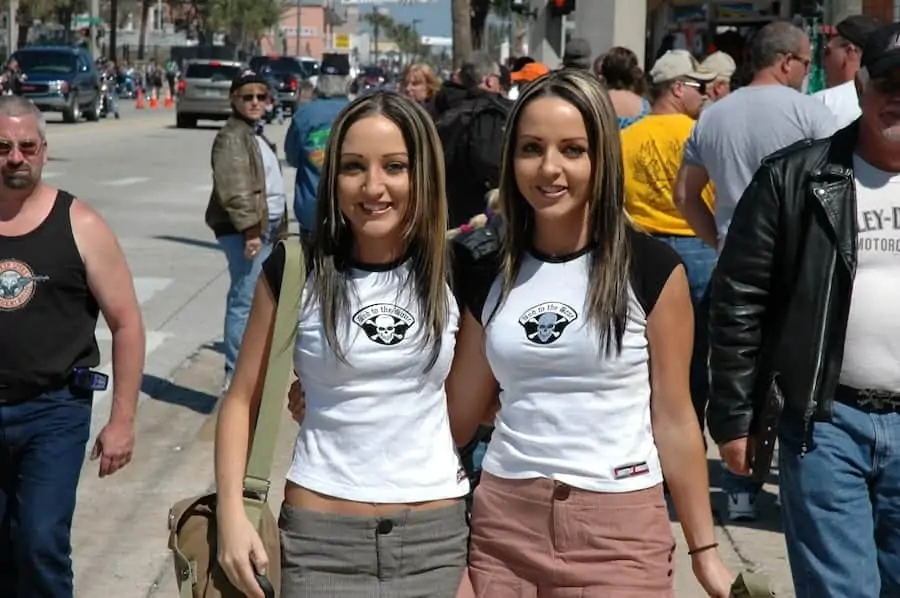 Twin girls pose on Daytona Main Street as Bike Week and Spring Break collide