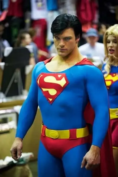 Superman at MegaCon, with Supergirl admiring from behind