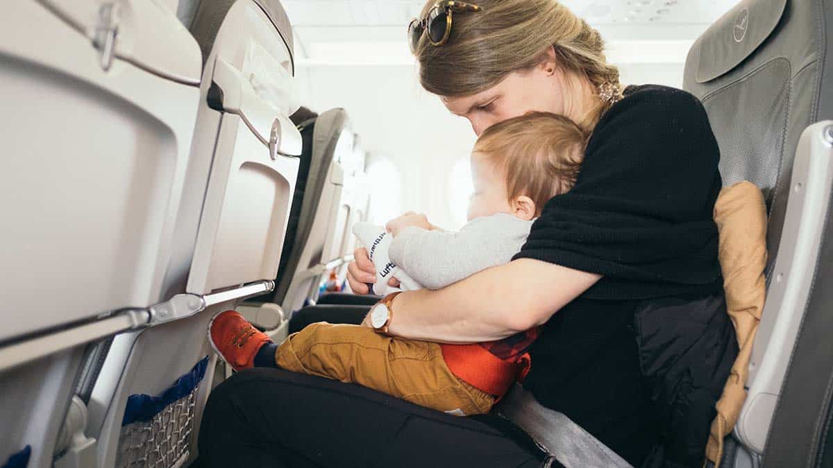 Mother Holding Child on Airplane